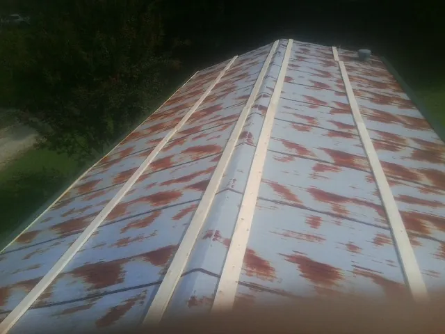 Rusted metal roof panels with new wood purlins before replacement — Storm Damage Roof Repair in Cherryville by Roofing Brothers